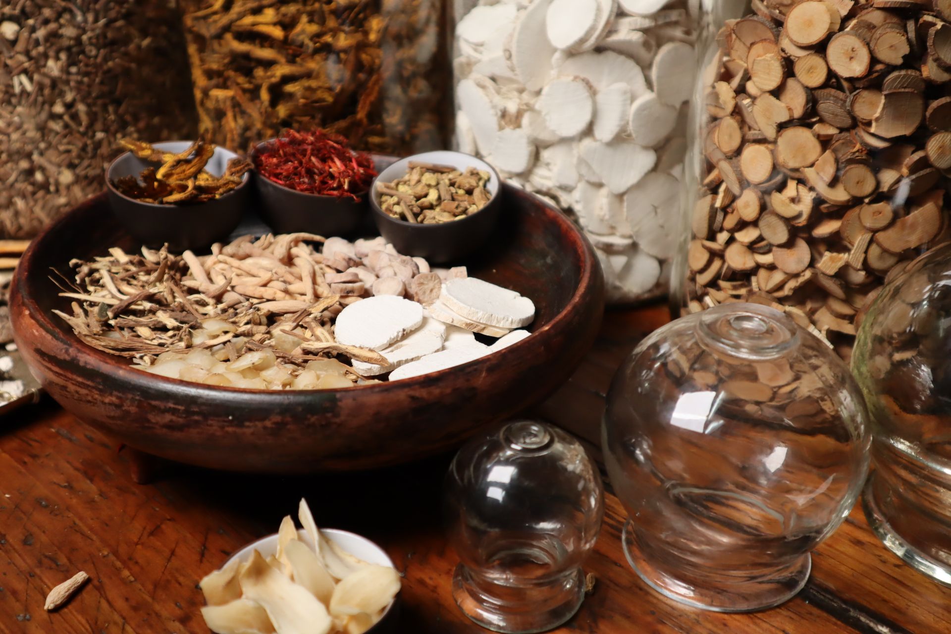 Chinese herbal medicine ingredients in a wooden bowl